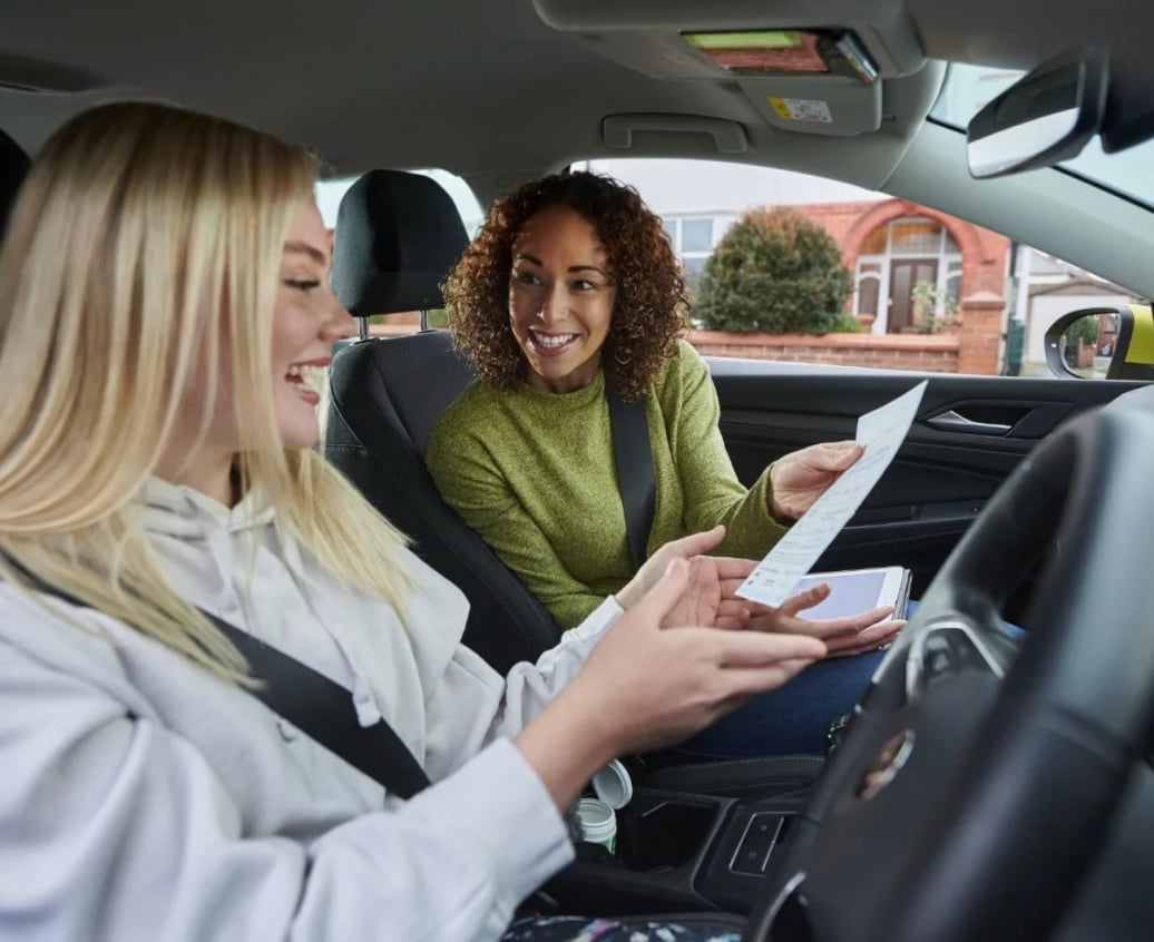 Learner driver reviewing driving test preparation materials on a laptop