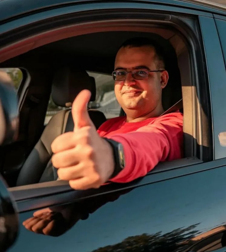Happy learner driver holding a driving test certificate – success story